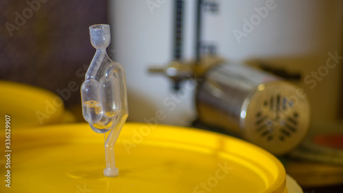 Фотография Airlock on a fermenting bucket for home beer brewing