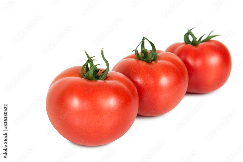 Three red tomatoes on a white background