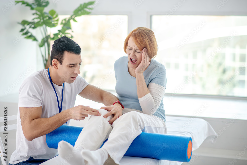 Red haired aged woman screaming from pain Red haired aged woman screaming from pain