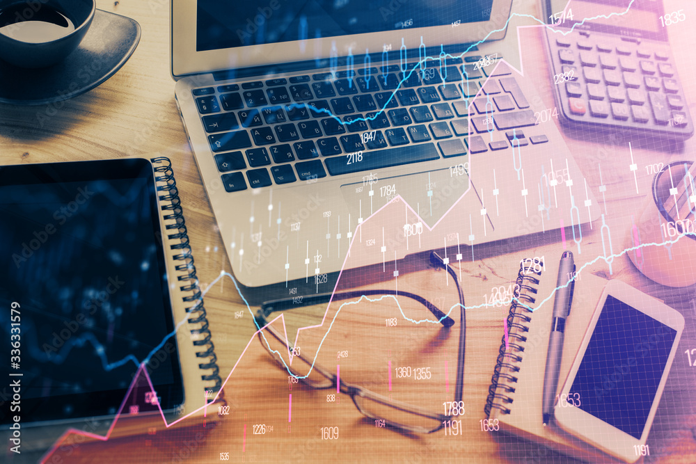 Double exposure of chart and financial info and work space with computer background. Concept of international online trading. Double exposure of chart and financial info and work space with computer background. Concept of international online trading.