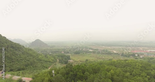 Aerial Pull Away Reaveal Shot from Bai Dinh moutain to Tam The Hall at Bai Dinh Temple Spiritual and Culture Complex in Ninh Binh Vietnam, the largest spiritual tourist place in Vietnam photo