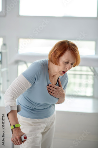 Fototapeta Naklejka Na Ścianę i Meble -  Unhappy senior woman feeling pain in the chest