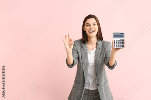Young woman with calculator...