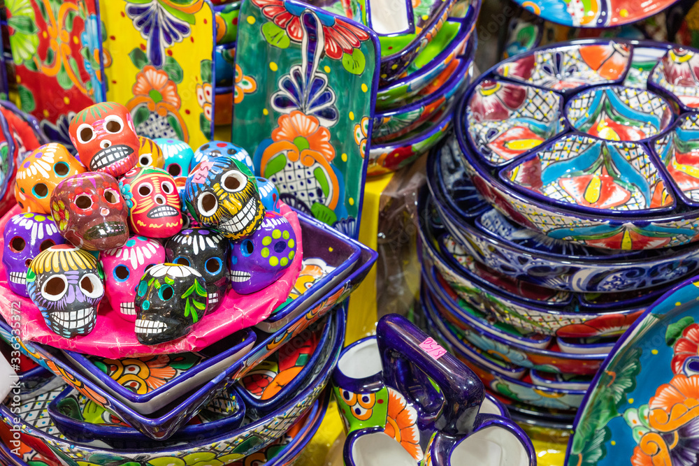 Colorful traditional Mexican pottery. Talavera style. Souvenirs on sale in local market of Guanajuato, Mexico.