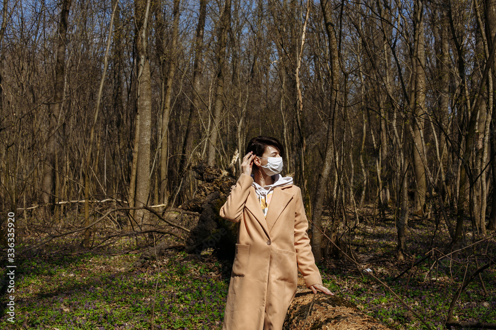 Obraz premium Self isolation. Masked walk in nature. virus attack