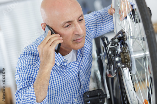 man talking to customer on the phoe photo