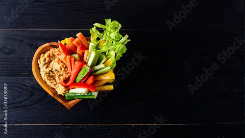 Hummus plate with a variety of vegetables and bread. Healthy snack or meze