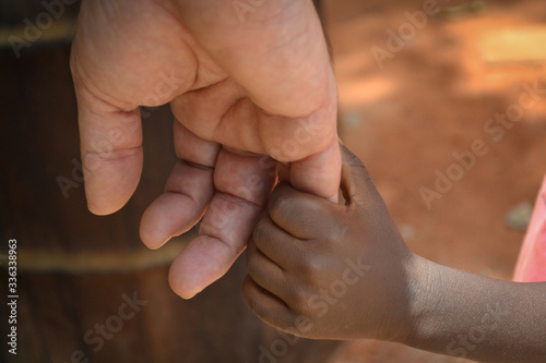 holding hands, black and white, man and boy, covid 19