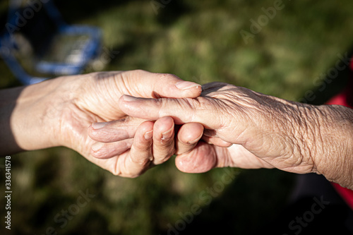 Young woman holding elderly hands © Jasmin Merdan