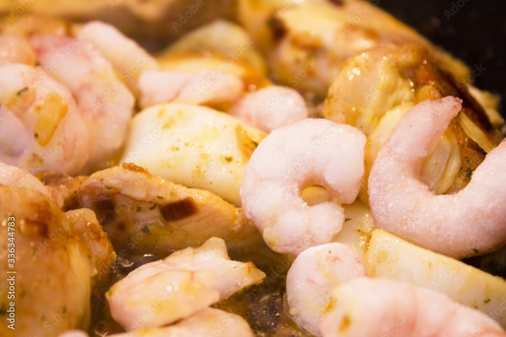 Vegetable stir fry with seafood and chicken to prepare paella Vegetable stir fry with seafood and chicken to prepare paella