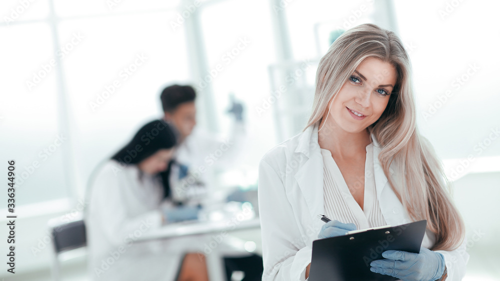 close up. female scientist taking notes on clipboard