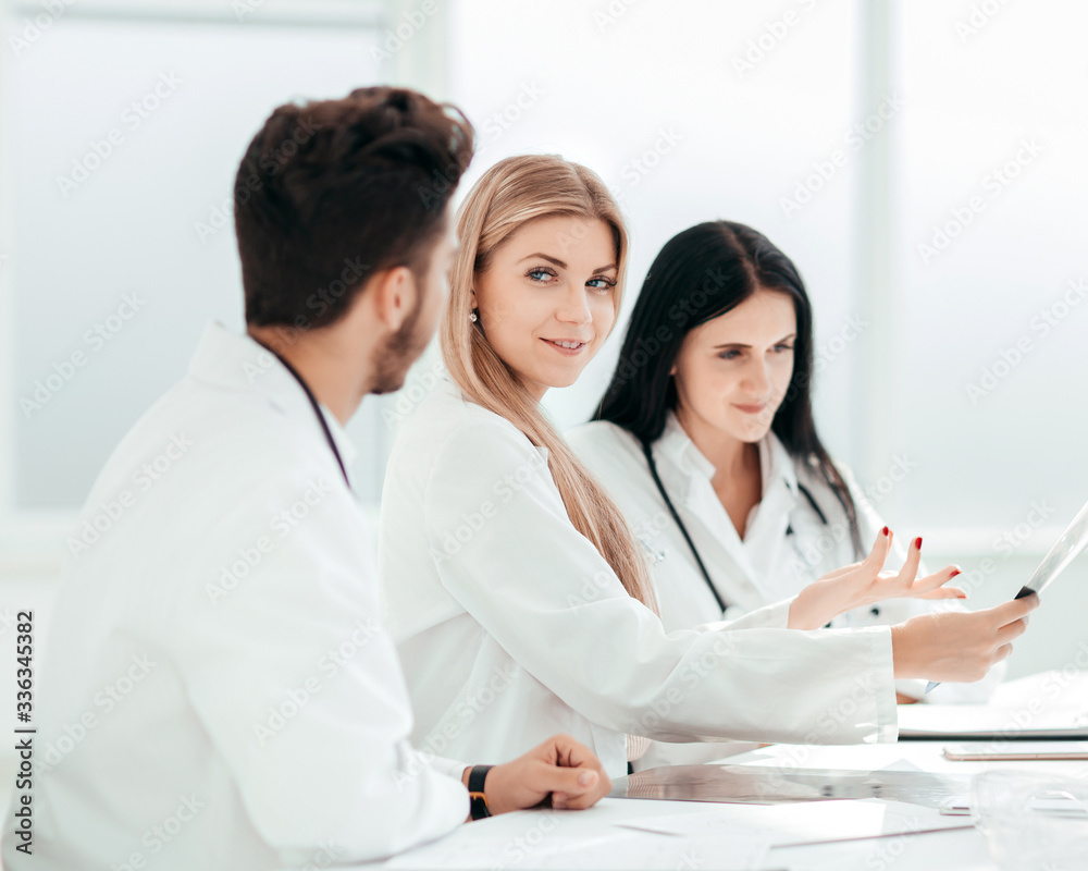 radiologist doctor showing an x-ray to her colleagues. radiologist doctor showing an x-ray to her colleagues.