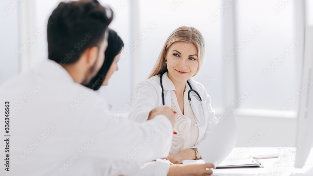 handshake of medical colleagues at the Desk in the office handshake of medical colleagues at the Desk in the office