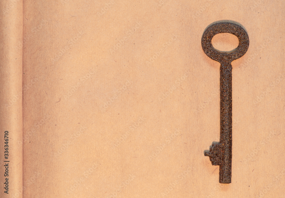 old key on paper background old key on paper background