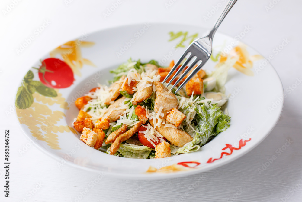 Caesar salad with chicken salad leaves on a light background, menu Caesar salad with chicken salad leaves on a light background, menu