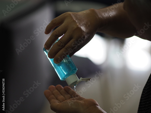 woman is standing with the finger to rub the gel alcoholic 70 percent mixture with gelatin on finger hand to prevent germs protect corona virus, covid19, hand Sanitizer