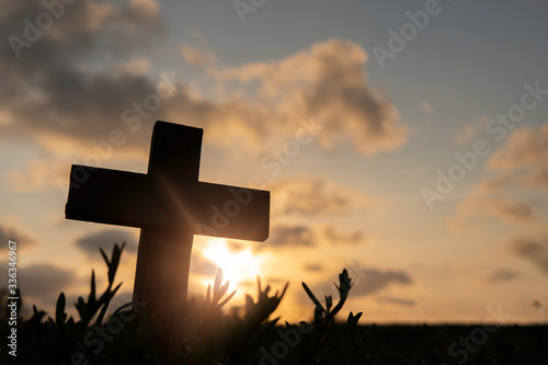 Silhouette Jesus christ death on cross crucifixion on calvary hill in sunset good friday risen in easter day concept for Christian praise for holy spirit religious God, Catholic praying background. photo