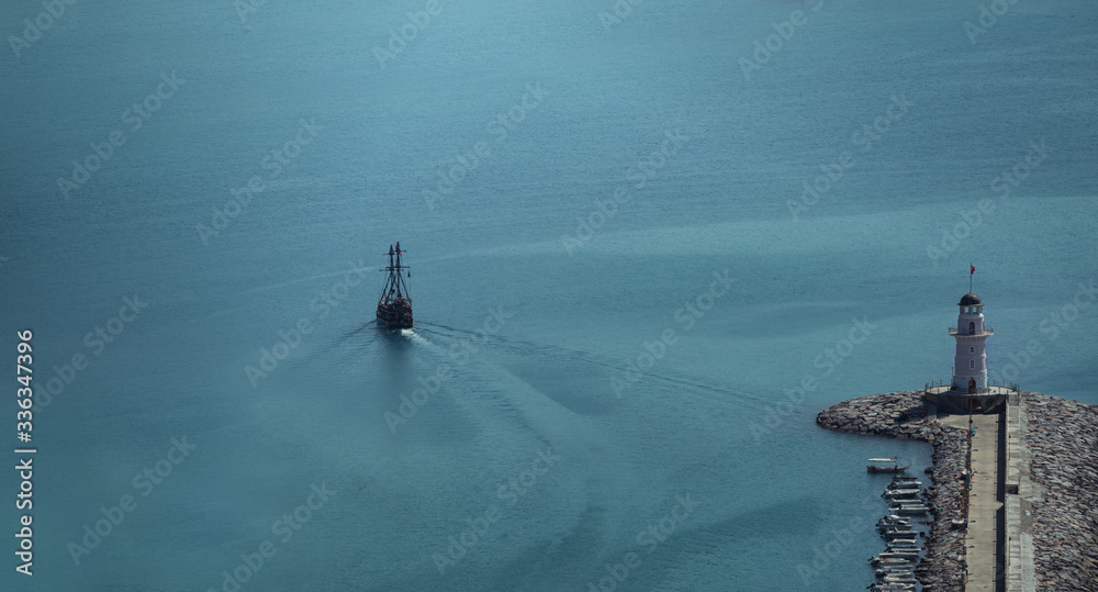 the ship passes the lighthouse