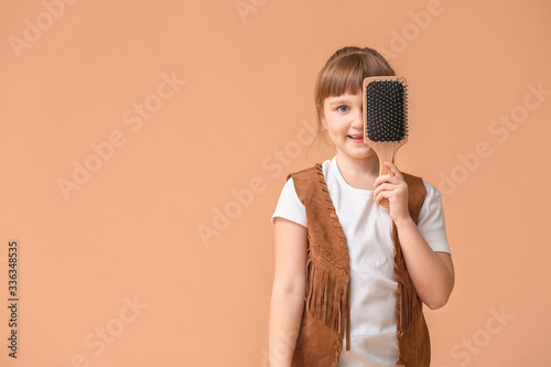 Little girl with hair brush...
