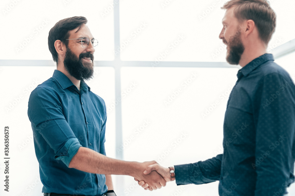 meeting and shaking hands with business people in a bright office meeting and shaking hands with business people in a bright office