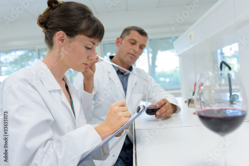 male and female oenologists working in a laboratory