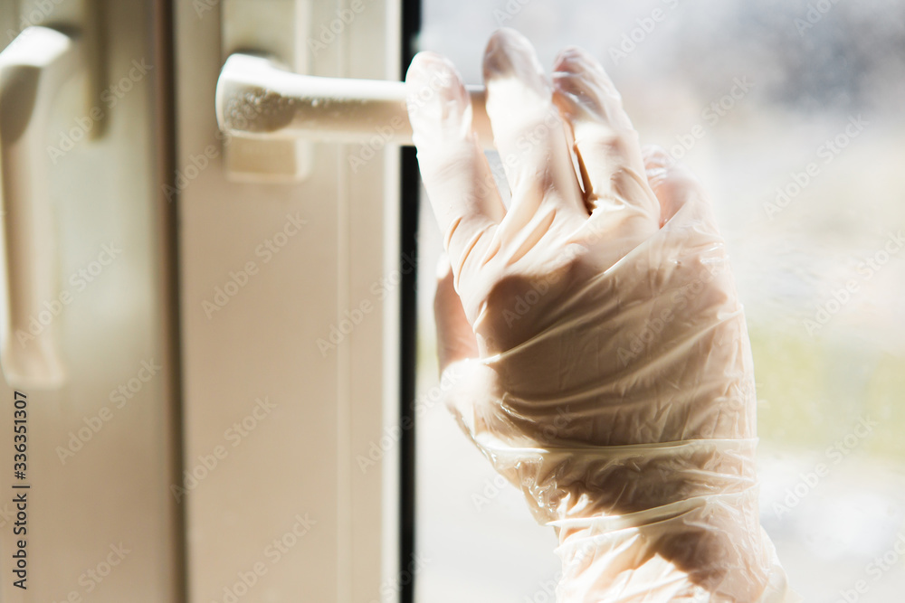 man in gloves washes window handles. Coronavirus disinfectants, asian flu outbreak, Coronavirus 2019-nCoV, Corona virus outbreaking. Spray bottle