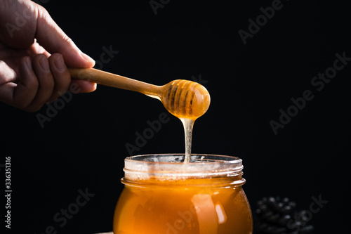 Honey in a glass jar,Scoop the honey in a glass jar