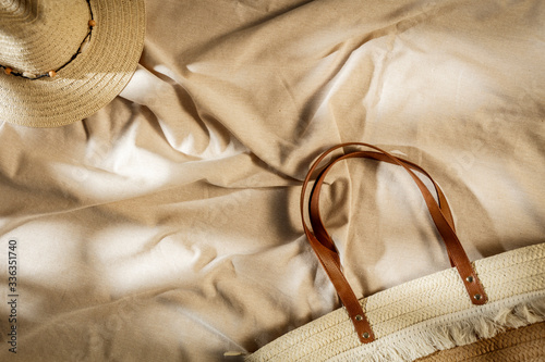 Summer tablecloth on the table with a hat with free space for holiday advertising products