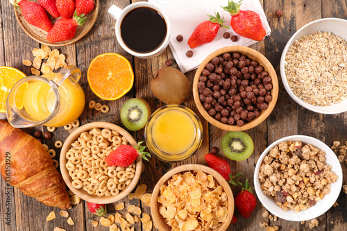 breakfast cereals assortment with orange juice, croissant and strawberry
