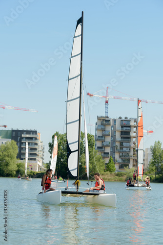 man and woman sail on yacht