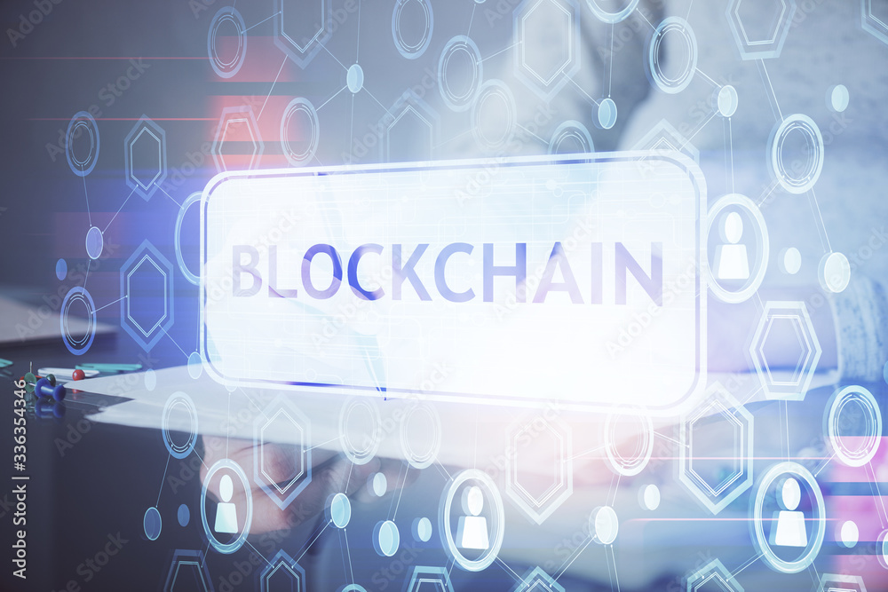 Cryptocurrency hologram over woman's hands writing background. Concept of blockchain. Multi exposure Cryptocurrency hologram over woman's hands writing background. Concept of blockchain. Multi exposure