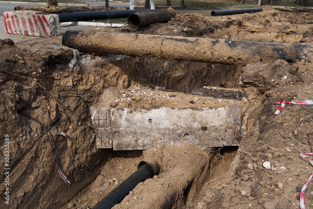 repair and replacement main pipeline of heating systems, district heating pipes network, water supply or Sewerage in city, removing old pipes and replacing them with new ones in a hole in the ground repair and replacement main pipeline of heating systems, district heating pipes network, water supply or Sewerage in city, removing old pipes and replacing them with new ones in a hole in the ground