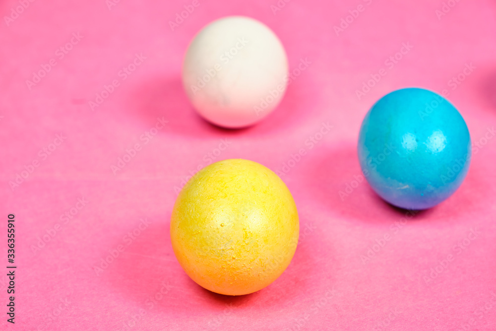 Multicolored, painted Easter eggs on a pink background. space for text Multicolored, painted Easter eggs on a pink background. space for text