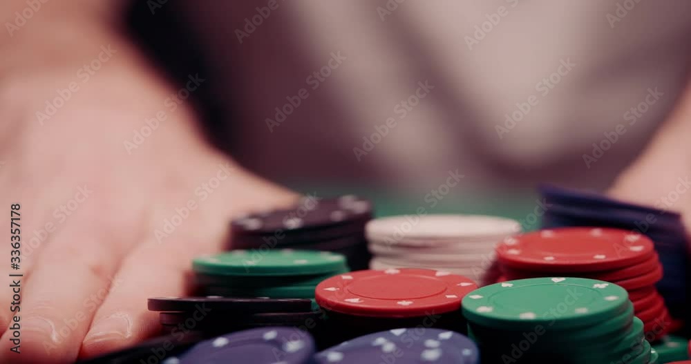 Close up of gambler pushing his chips all in towards the cam shot in 4k super slow motion Close up of gambler pushing his chips all in towards the cam shot in 4k super slow motion