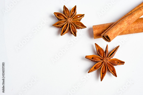 Anise stars, Badian and cinnamon on a white background, space for text,lat lay.
