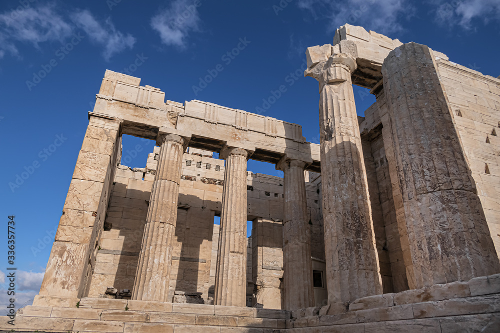 Ancient Greek ruins of Propylaea on a top of Acropolis hill in Athens. Acropolis - main tourist attraction of Athens. Greece.