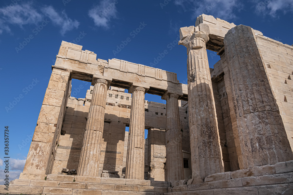 Obraz premium Ancient Greek ruins of Propylaea on a top of Acropolis hill in Athens. Acropolis - main tourist attraction of Athens. Greece.