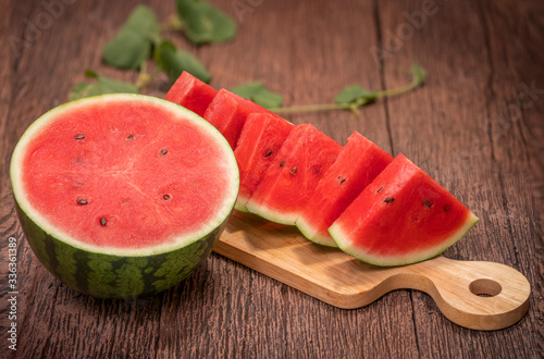 Watermelon fruit with leaves on the old wooden table  Watermelon with slice on wooden Background