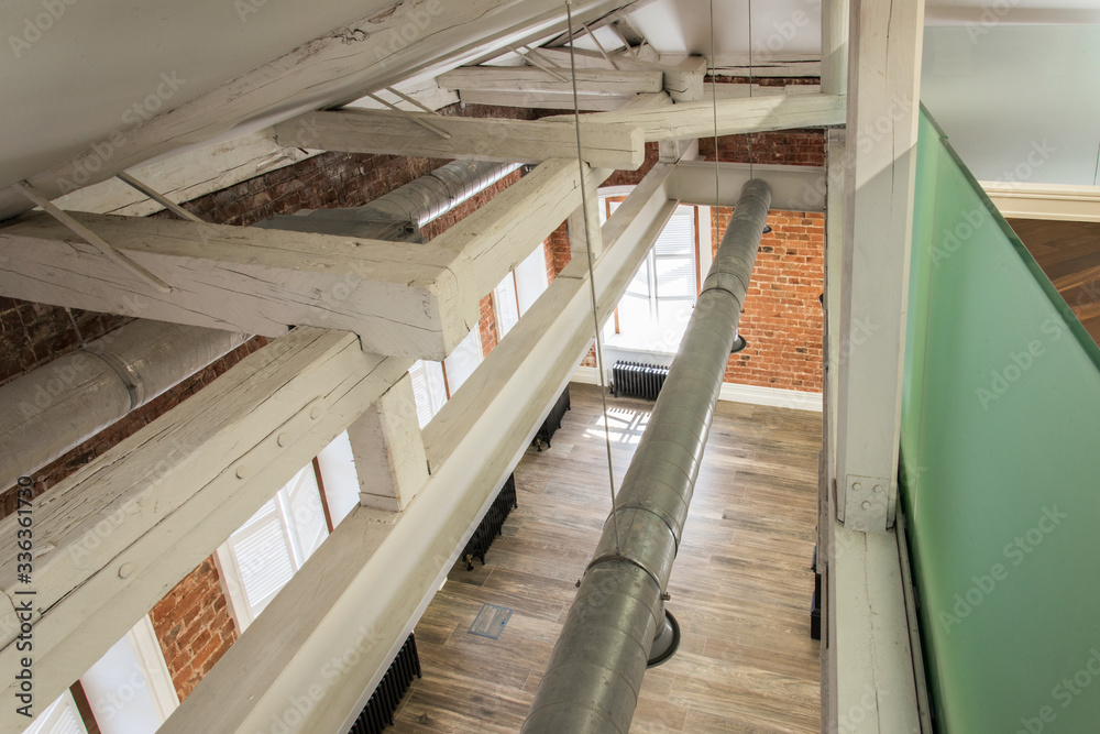 Fototapeta premium wooden construction of the roof overlap. the wooden skeleton is reinforced with metal beams after reconstruction.
