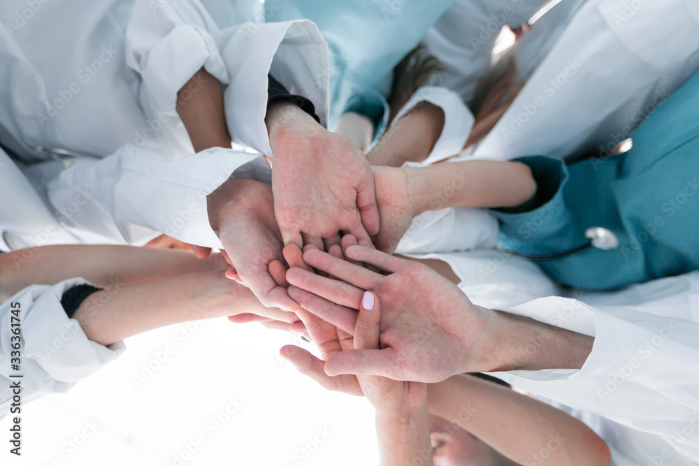 bottom view. group of diverse doctors showing their unity bottom view. group of diverse doctors showing their unity