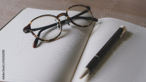 notebook and glasses and pens