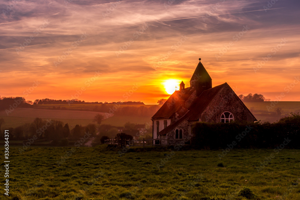 Sunset over the South Downs National Park at Idsworth with the ioslated St Hubert's church in the foreground. Hampshire, UK