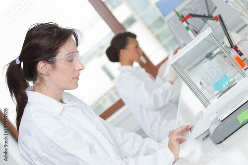female laboratory technician using electronic scales