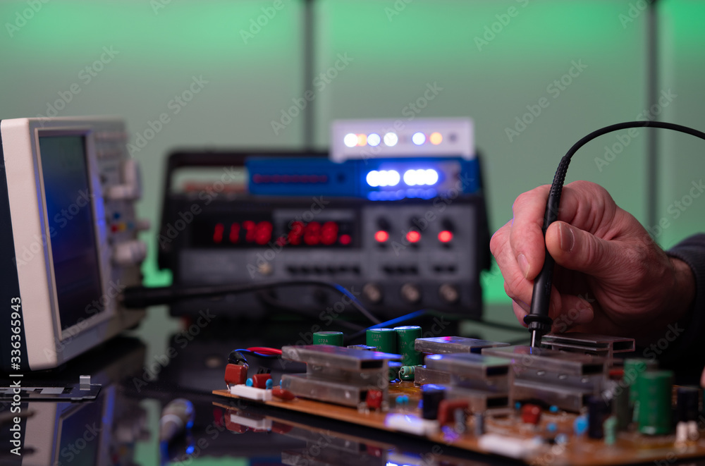 Debugging electronics device. PCB witch microcontroller in electronics laboratory