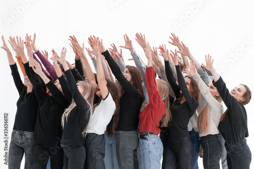 Fotografie group of diverse young people holding their hands up