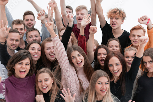 large group of happy young people looking at the camera