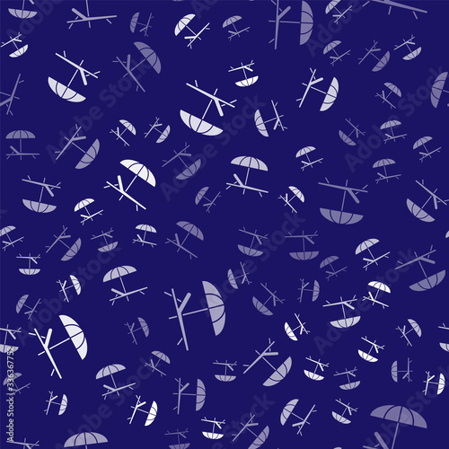 White Sunbed icon isolated seamless pattern on blue background. Beach umbrella and Sun lounger. Vector Illustration