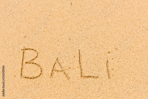 Bali sign on a sandy beach. Background close up. © leo_nik