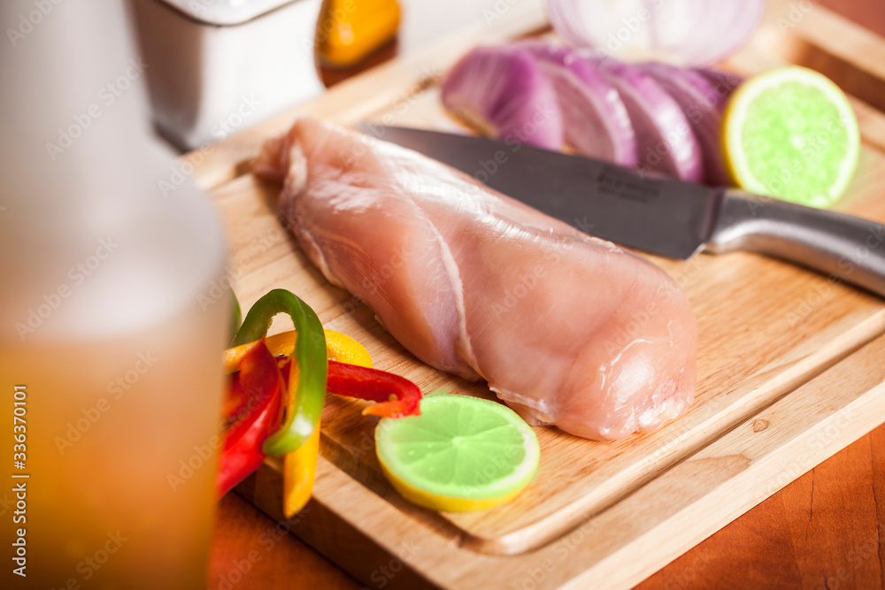 A slice of chicken breast with lemons and peppers A slice of chicken breast with lemons and peppers