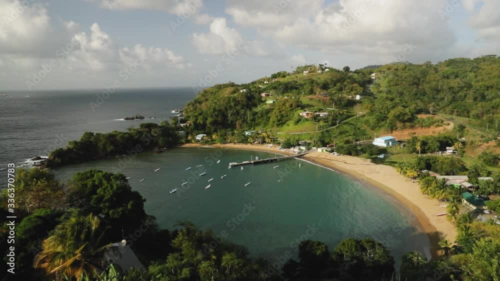 Lookout view over a beautiful fishing village on the ocean side with blue water and sandy beaches in Tobago, West Indies. Lookout view over a beautiful fishing village on the ocean side with blue water and sandy beaches in Tobago, West Indies.
